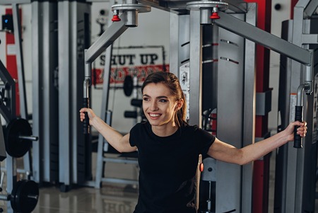 beautiful girl is engaged on a simulator at the fitness clubの写真素材