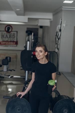 She holds a shaker with sports nutritionの写真素材