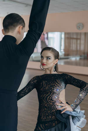 Professional dancers dancing in ballroom. Latin. Young boy and girl