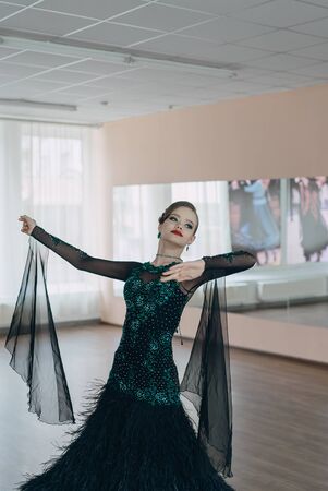 Professional dancers dancing in ballroom. Young girlの写真素材