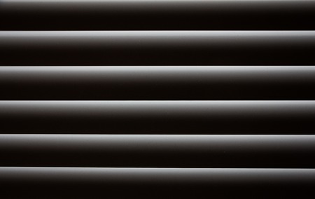 Closed blinds through which light hardly passes. Abstract background blindsの写真素材