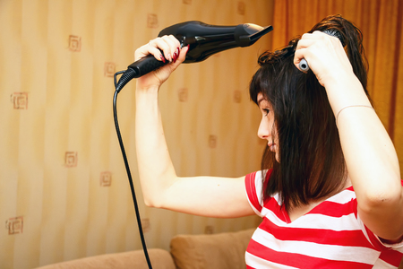 Girl dries hairの写真素材