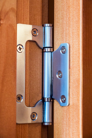 Steel hinge on the wooden door
