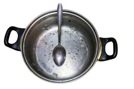 Unwashed pot with spoon isolated on white backgroundの写真素材