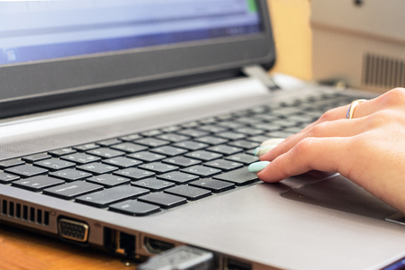 Woman's hand on laptop keyboard. Selective focusの写真素材