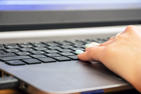 Womans hand on laptop keyboard. Selective focusの写真素材
