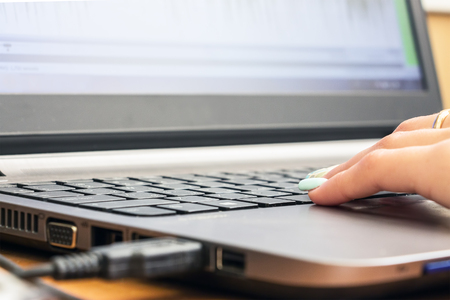Womans hand on laptop keyboard. Selective focusの写真素材