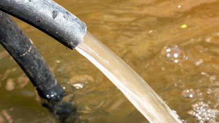 Water is poured from the hose. Close-up