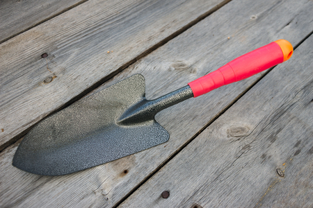 Small garden shovel on an old wooden background 3の写真素材