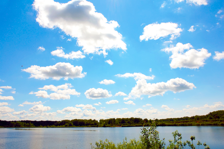 Landscape with clouds in blue sky over riverの写真素材