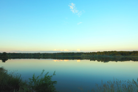 Beautiful sky over lake with still waterの写真素材