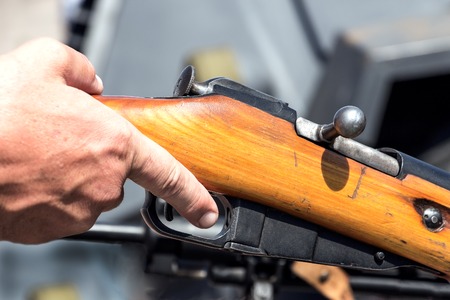 Finger on the trigger of the old rifleの写真素材