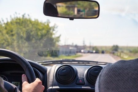Men hands on the wheel of a car.の写真素材