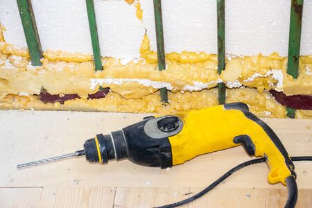 Electric drill on a wooden floor. Repairs in the roomの写真素材
