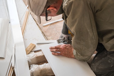 The builder works with white plastic partsの写真素材