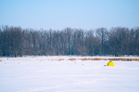 Tent for winter fishing on a frozen lake. Winter landscapeの写真素材