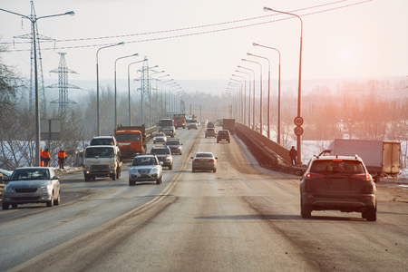 Public road roadway for transport vehicles in sunlight. Along the edges of the road, lamppostsの写真素材