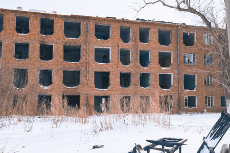 The old abandoned house of red brick without windows. Windows without framesの写真素材