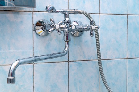 Faucet mixer tap in bathroom on tile backgroundの写真素材