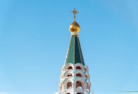 Orthodox cross on the dome of the Church against the clear blue sky