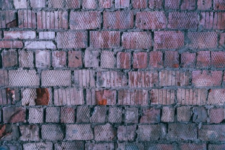 The old wall of a square red brick. Background and texture