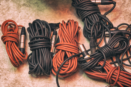 Audio cables for musical instruments and microphones on the floorの写真素材