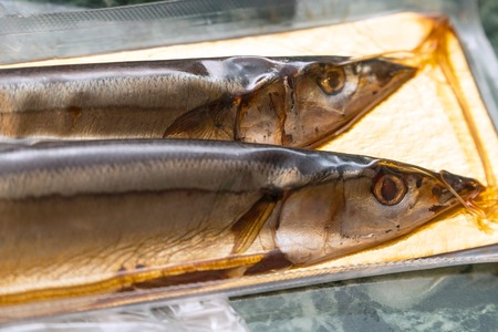 Sea fish saury in vacuum packaging on the table. Selective focusの写真素材
