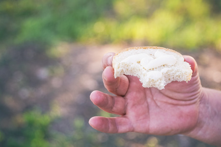 Snack Bread with mayonnaise in hand. Selective focusの写真素材