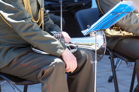 Military band musician sitting on a chair with a wind instrument baritoneの写真素材