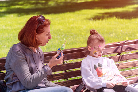 Russia, Samara, May 27, 2018: Girl with mom on a Park benchのeditorial素材