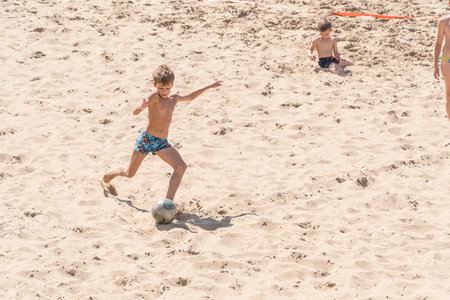 SAMARA, RUSSIA - JUNE 21, 2018: Boy playing soccer on the beachのeditorial素材