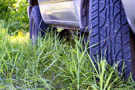 Wheels a car SUV in the forest grass. Selective focusの写真素材