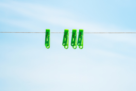 Clothespins on a rope against the skyの写真素材