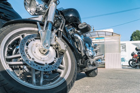 Motorcycle in the Parking lot. View motorcycle front bottom. Front wheel, headlight. Soft focusの写真素材