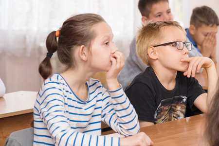 CHAPAEVSK, SAMARA REGION, RUSSIA - OCTOBER 24, 2018: School kids in the classroom sitting at their desks and listen to the teacher. Selective focusのeditorial素材