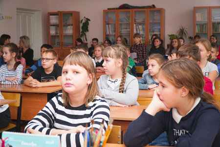 CHAPAEVSK, SAMARA REGION, RUSSIA - OCTOBER 24, 2018: School kids in the classroom sitting at their desks and listen to the teacher. Selective focusのeditorial素材