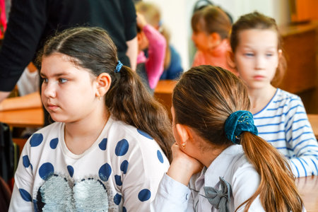 CHAPAEVSK, SAMARA REGION, RUSSIA - OCTOBER 24, 2018: Two girls in the classroom at the Desk listening to the teacher. Selective focusのeditorial素材