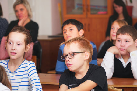 CHAPAEVSK, SAMARA REGION, RUSSIA - OCTOBER 24, 2018: School kids in the classroom sitting at their desks and listen to the teacherのeditorial素材