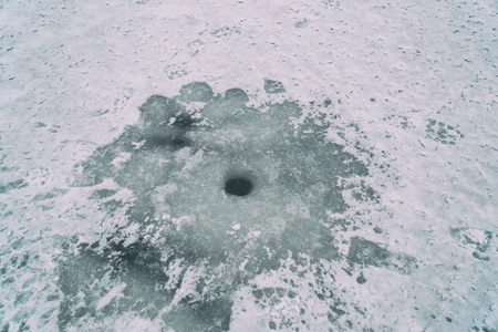 Ice hole in the ice for winter fishingの写真素材