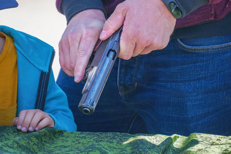 The gun in the man's hand. Reloads the gun