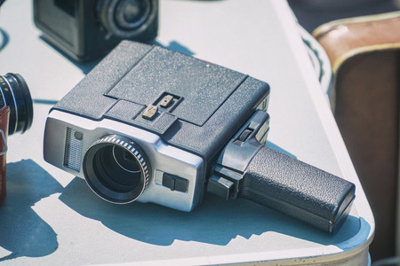 Old vintage movie camera on the tableの写真素材