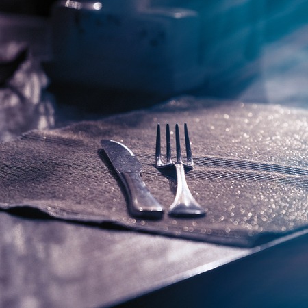 A fork and a knife on the table on a dark napkin. Selective focusの写真素材