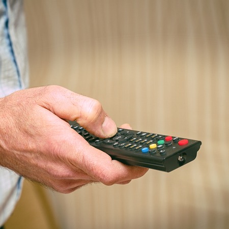 TV remote in the hand of a man