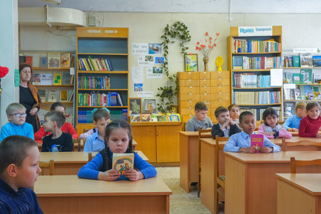 Chapaevsk, Samara region, Russia - May 10, 2019: Elementary school of the city of Chapaevsk. Schoolchildren sit at their desks, holding books and listen to teachers. Soft focusのeditorial素材