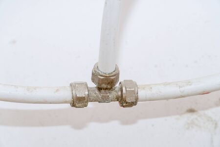 Old connection fitting tee on plastic water pipes