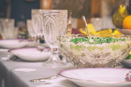Festive table setting with crystal glasses and plates. Selective focusの写真素材