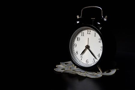 Classic mechanical alarm clock on dark background. Low keyの写真素材