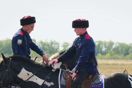 Samara, Russia - August 17, 2019: Young Cossacks in traditional costumes on horseback