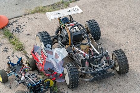 Disassembled RC model racing cars. Model cars without top. Radio controlled car model frame