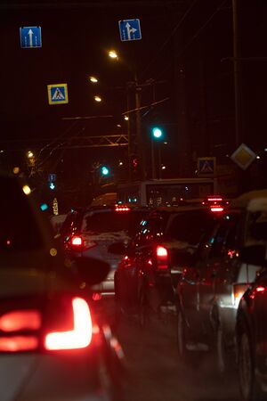 Cars in a winter night traffic jam in the city at night. Selective focus